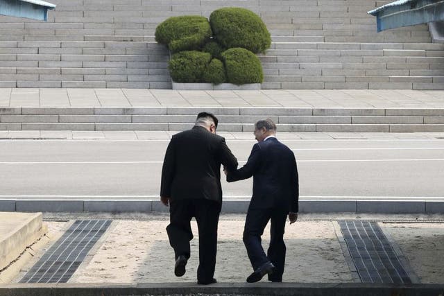 The reportedly unscripted moment at which North Korean leader Kim Jong-un, left, and South Korean president Moon Jae-in briefly cross the border line into the North together