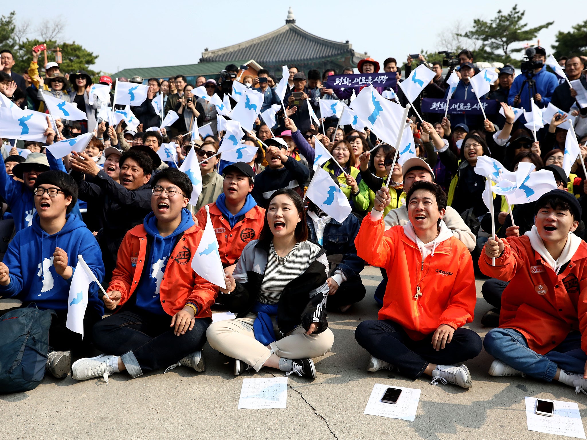 South Koreans react while watching a screen reporting the Inter Korean Summit