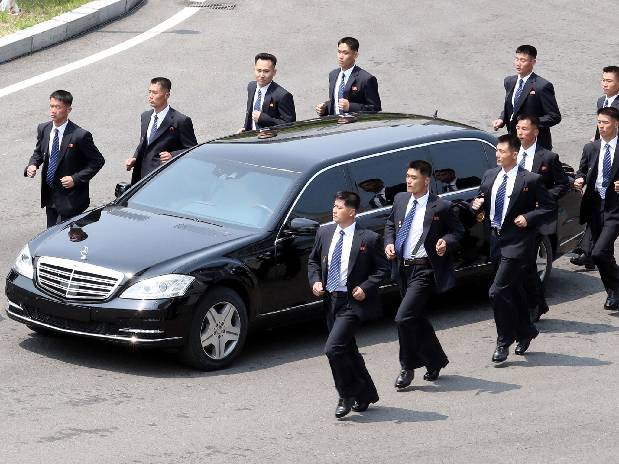 Kim Jong Uns Official Car Flanked By 12 Bodyguards Running In