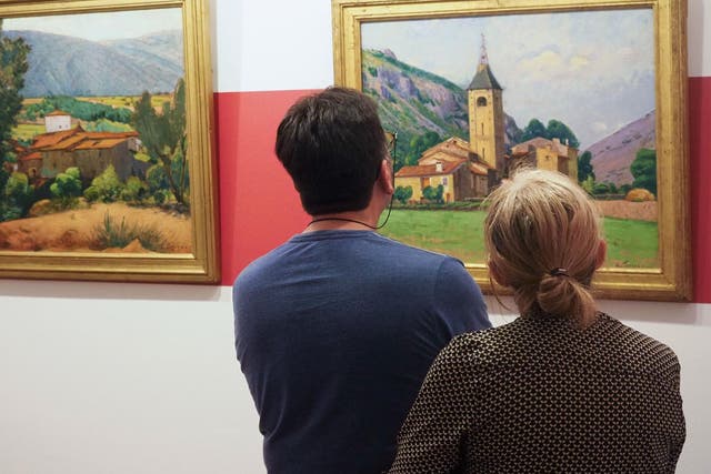 Visitors look at paintings by Etienne Terrus at the reopening of the Terrus Museum in Elne