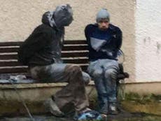 Two men wanted by police found tied to bench and covered in paint