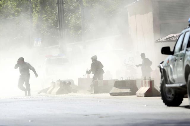 Security forces run from the site of a suicide attack in Kabul, Afghanistan, on Monday 30 April 2018
