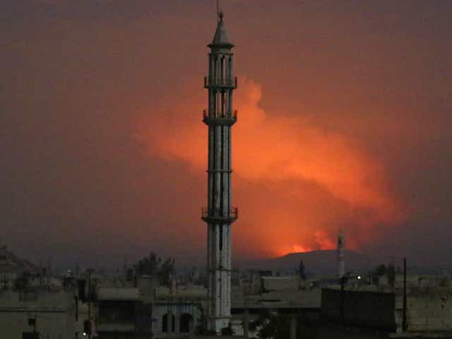 Smoke rises after military points of the 47th regiment of the Assad regime were hit in Hama