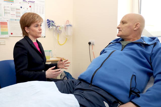 Scottish First Minister Nicola Sturgeon meets patient Thomas Crawford during a visit to the Edinburgh Royal Infirmary, as she marks the minimum unit pricing for alcohol coming into force