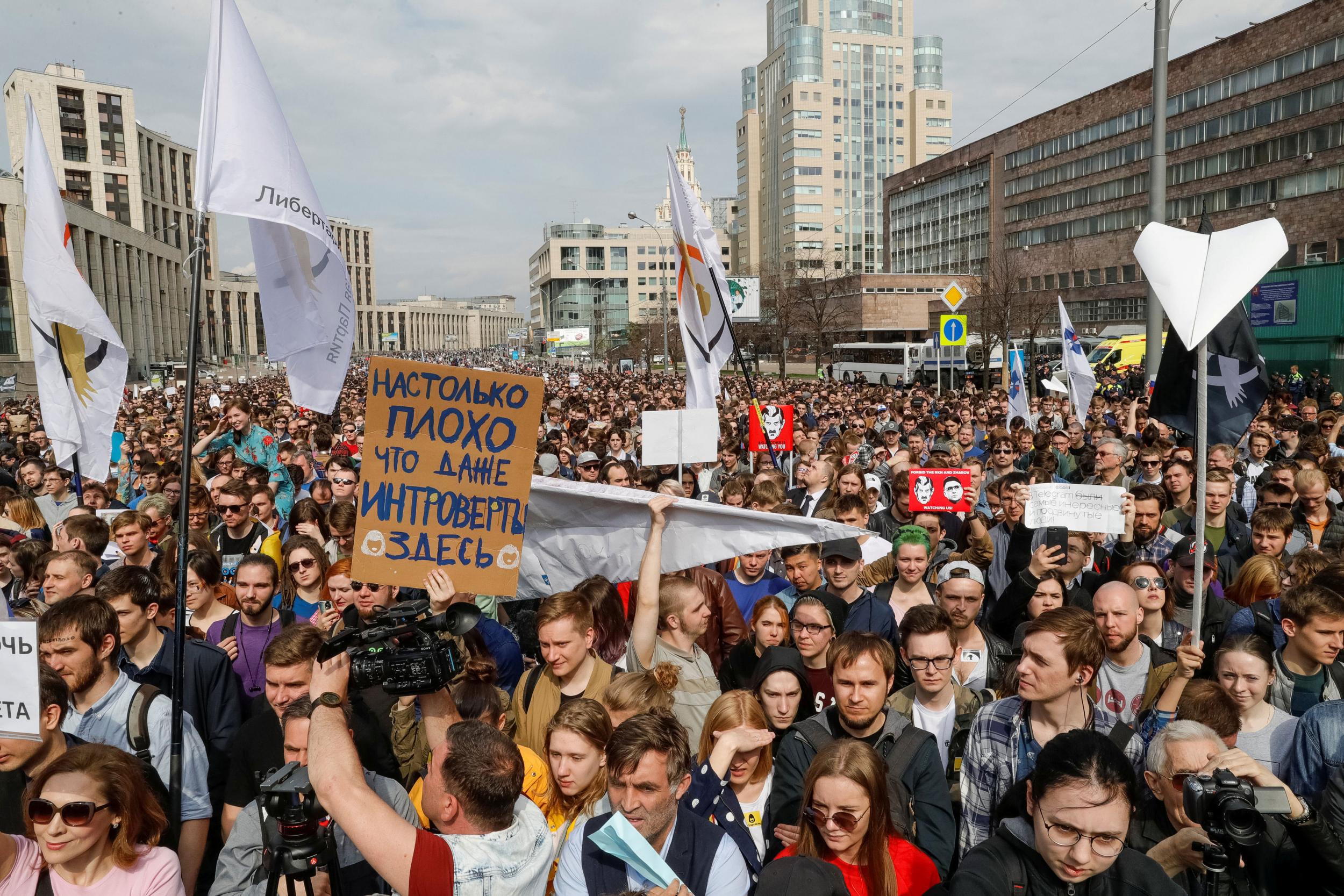Protesters carry paper aeroplanes in Moscow – a reference to the banned app’s logo