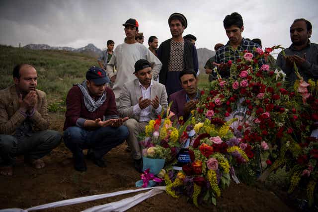 Friends and relatives of Shah Marai Faizi, chief photographer in Afghanistan for global news agency Agence France-Presse, gather at his funeral in Gul Dara, Kabul, on Monday