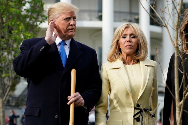 Donald Trump listens to a question as he stands wtih Brigitte Macron on the South Lawn of the White House in Washington, U.S., April 23, 2018