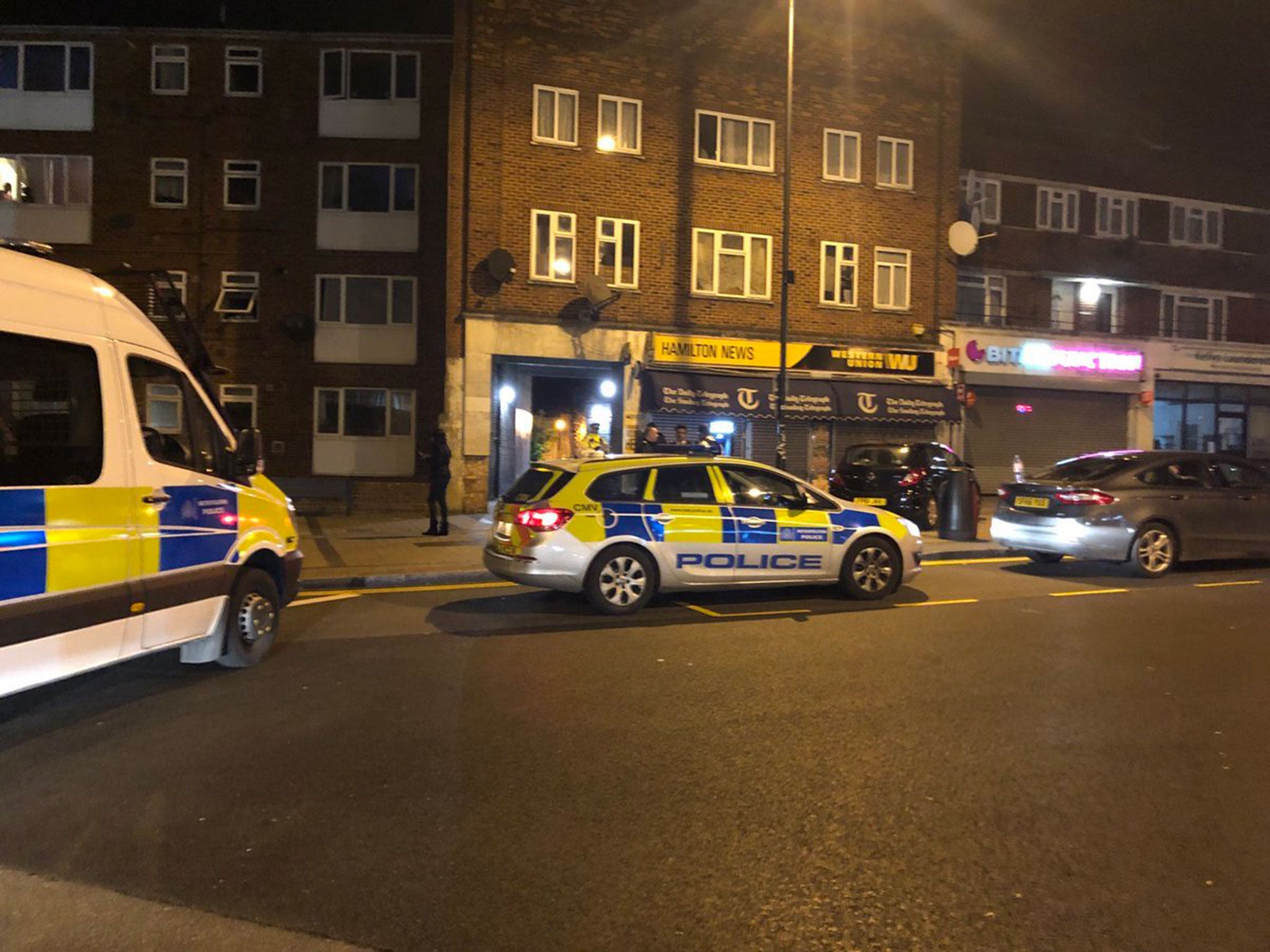 Police at the scene of a shooting in Queensbury, London.