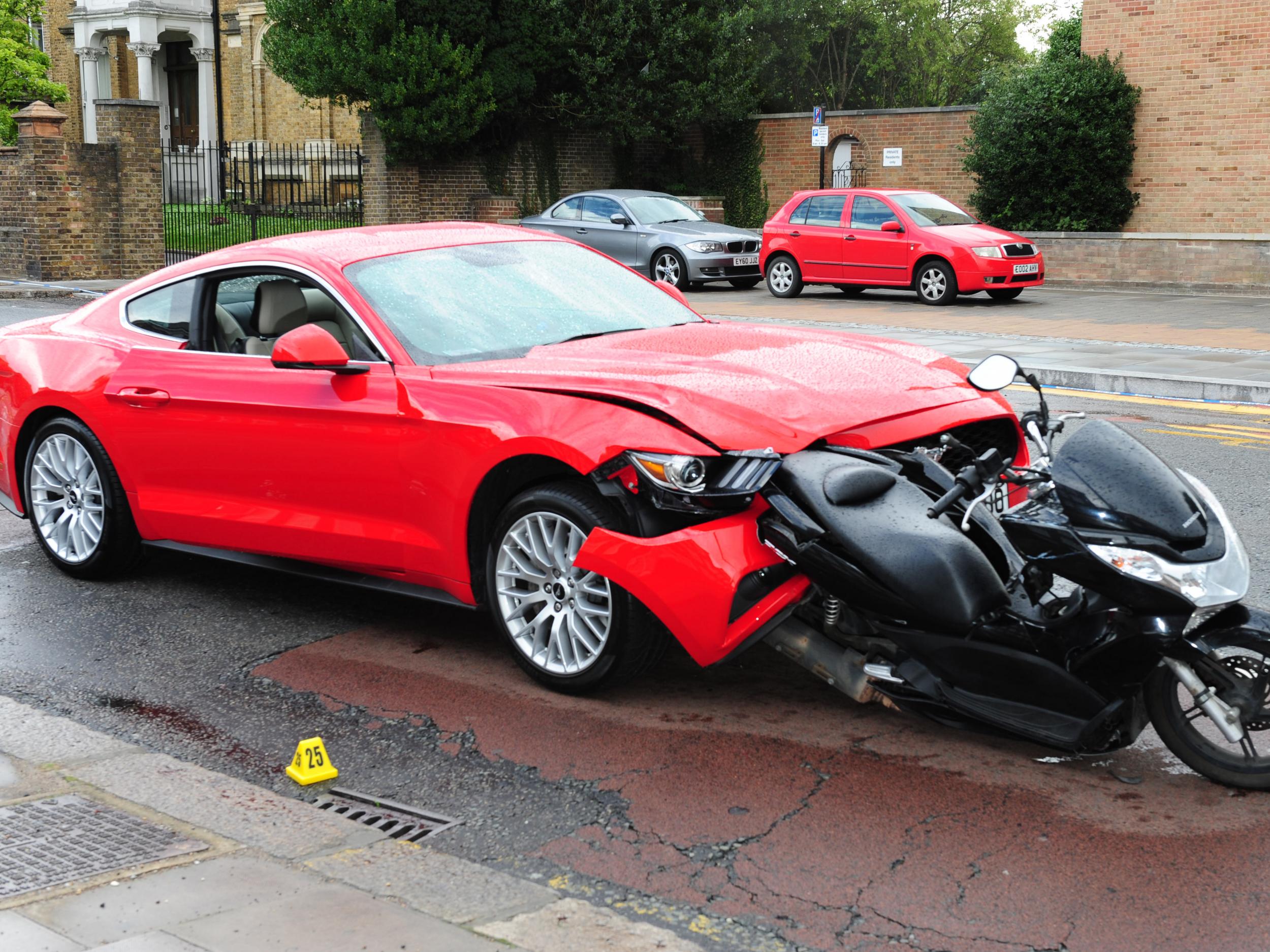 Bradley Clifford's red Ford Mustang after he crashed it into the moped carrying Soban Khan and Jahshua Francis in Enfield