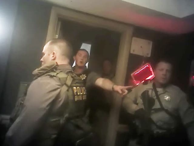 This photo from police officer video body camera footage on 1 October, 2017, provided by the Las Vegas Metropolitan Police Department, shows officers as they breach the shooter's room during the deadliest mass shooting in modern US history by Stephen Paddock, at the Mandalay Bay Hotel in Las Vegas