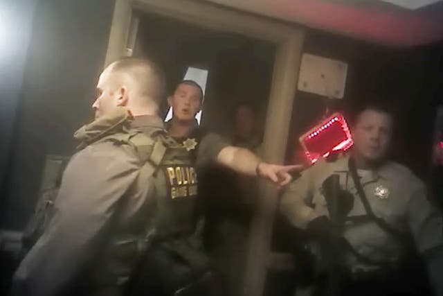 This photo from police officer video body camera footage on 1 October, 2017, provided by the Las Vegas Metropolitan Police Department, shows officers as they breach the shooter's room during the deadliest mass shooting in modern US history by Stephen Paddock, at the Mandalay Bay Hotel in Las Vegas