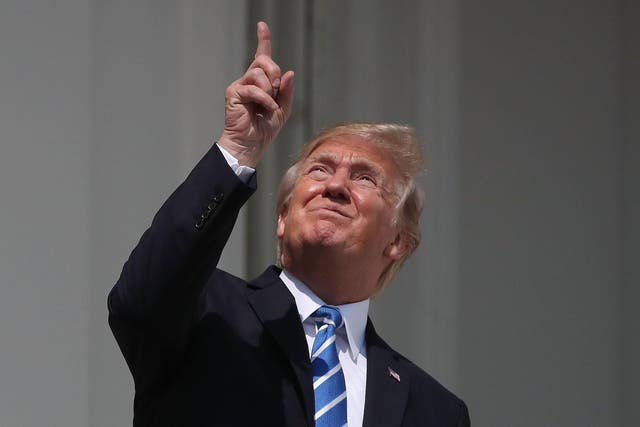 U.S. President Donald Trump looks up toward the Solar Eclipse on the Truman Balcony at the White House on August 21, 2017 in Washington, DC