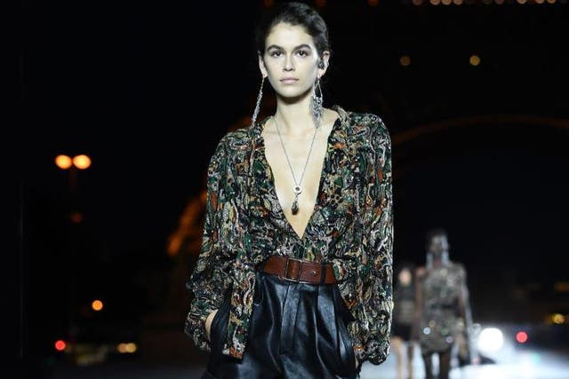 A leather variant contrasts a floaty, feminine blouse at Saint Laurent