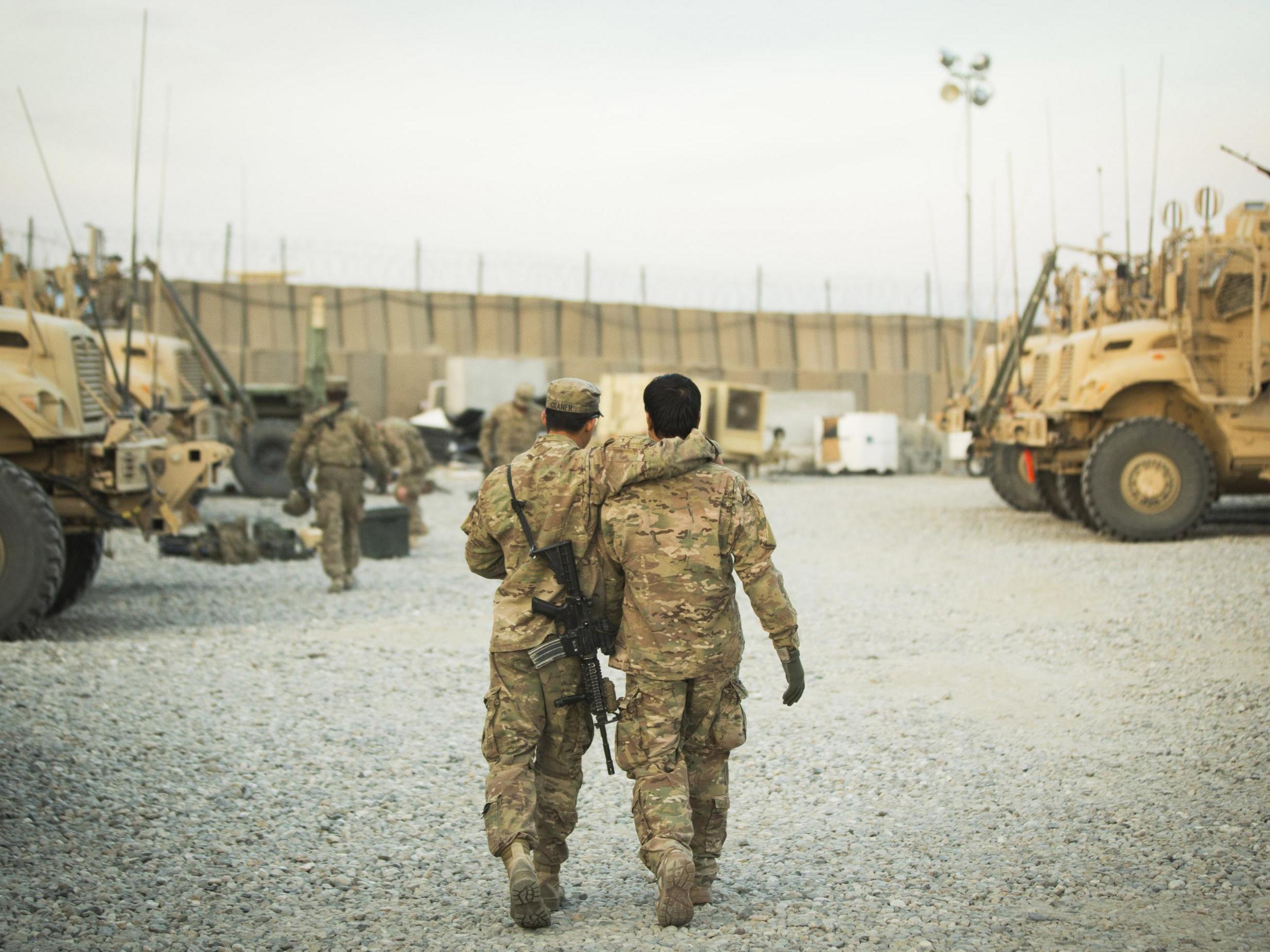 A US soldier walks with an Afghan interpreter before a mission