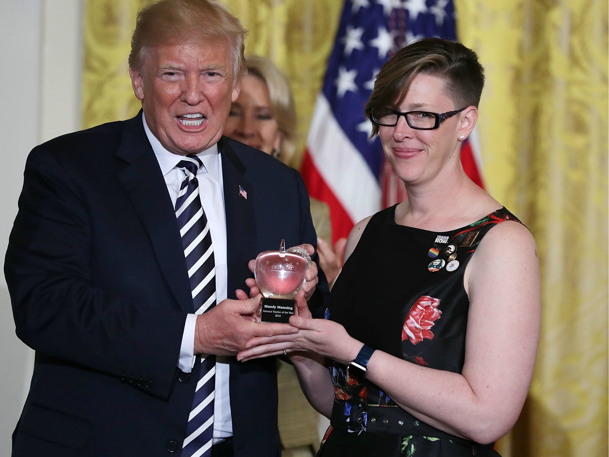 US President Donald Trump gives the National Teacher of the Year trophy to Mandy Manning during a ceremony at the White House 2 May 2018.