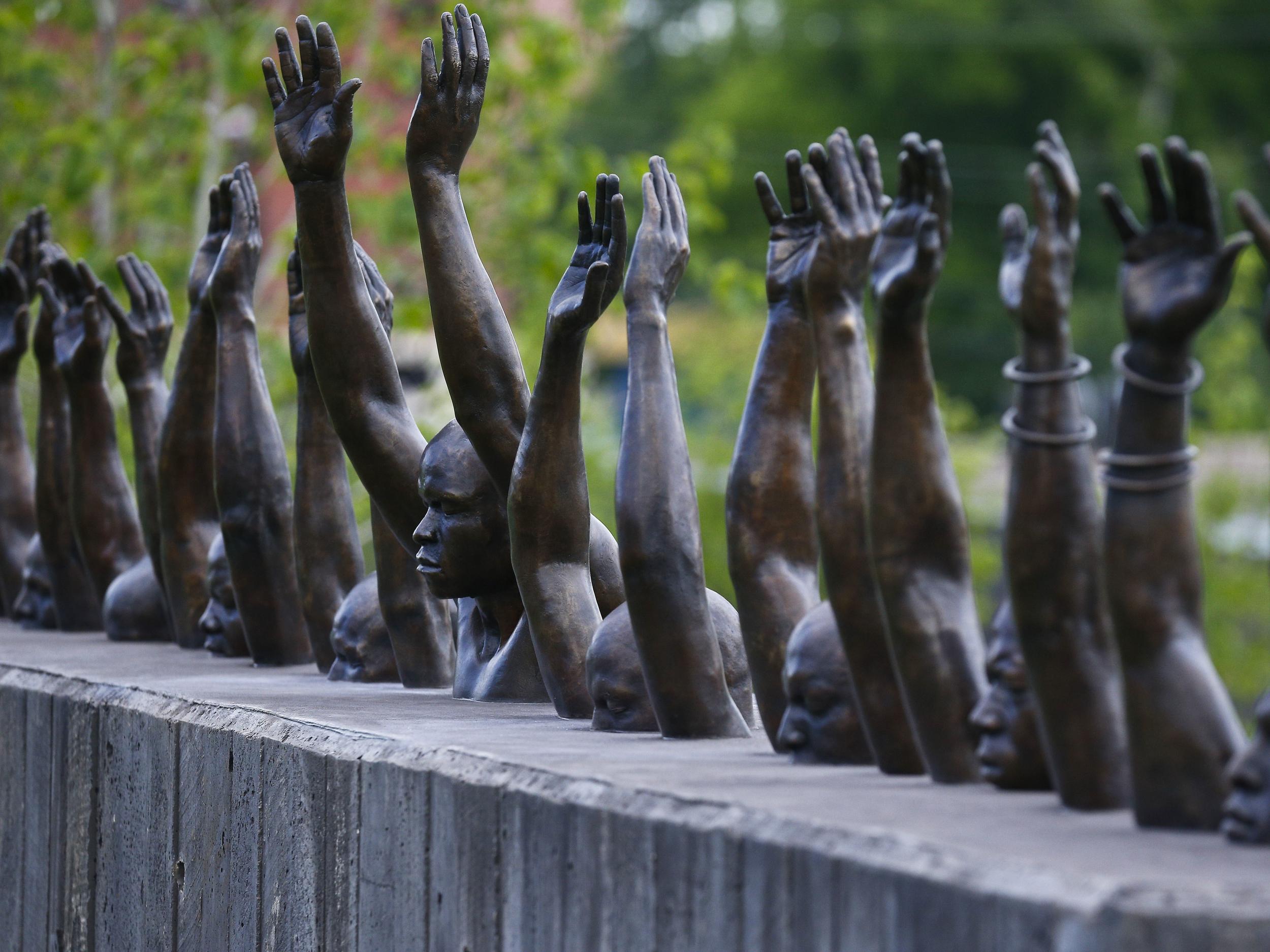 Bronze statue called ‘Raise Up’, part of the display at the National Memorial for Peace and Justice