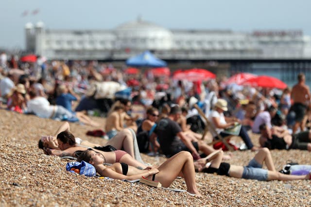 People sun bathing on Brighton Beach