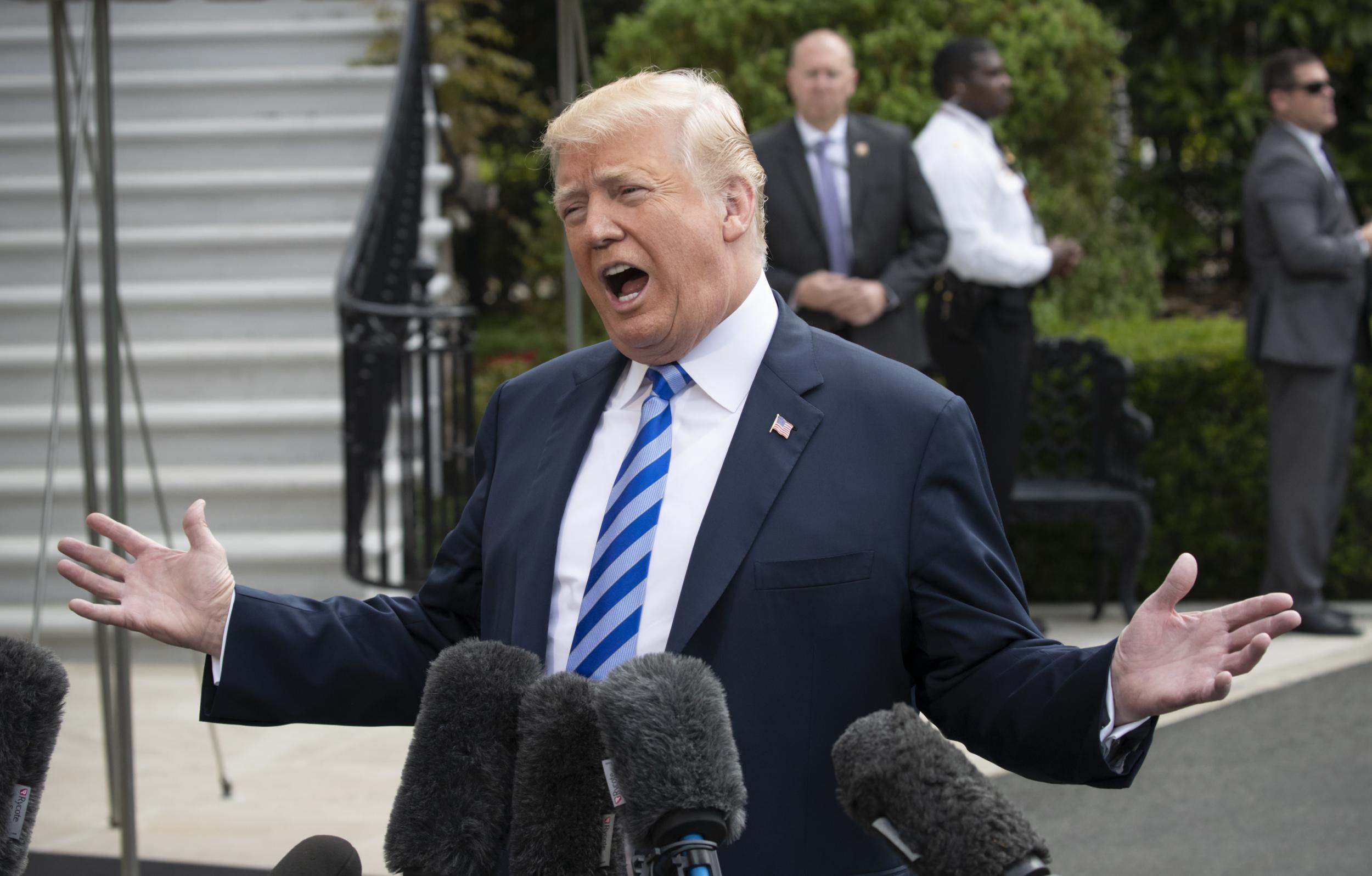 President Donald Trump talks to the media as he leaves for Dallas to address the National Rifle Association