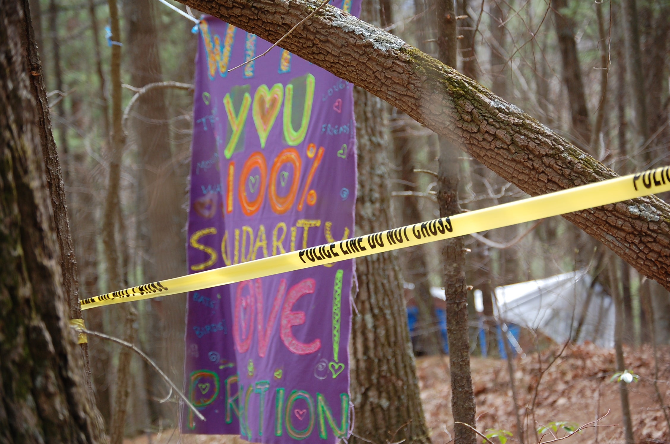 Protest banners hang outside the construction area closed off by the US Forest Service