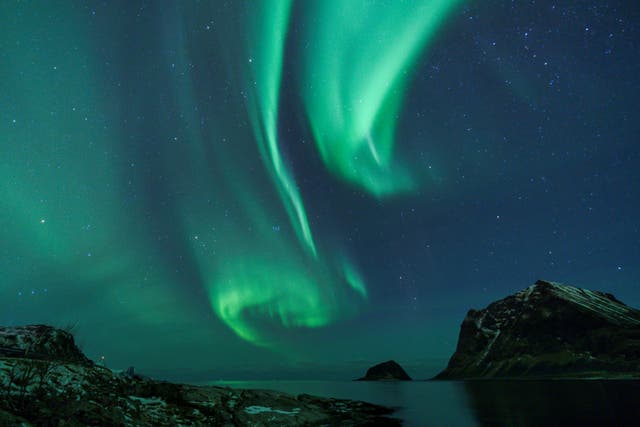 Northern Lights are pictured in Utakleiv, northern Norway, Lofoten islands, within the Arctic Circle