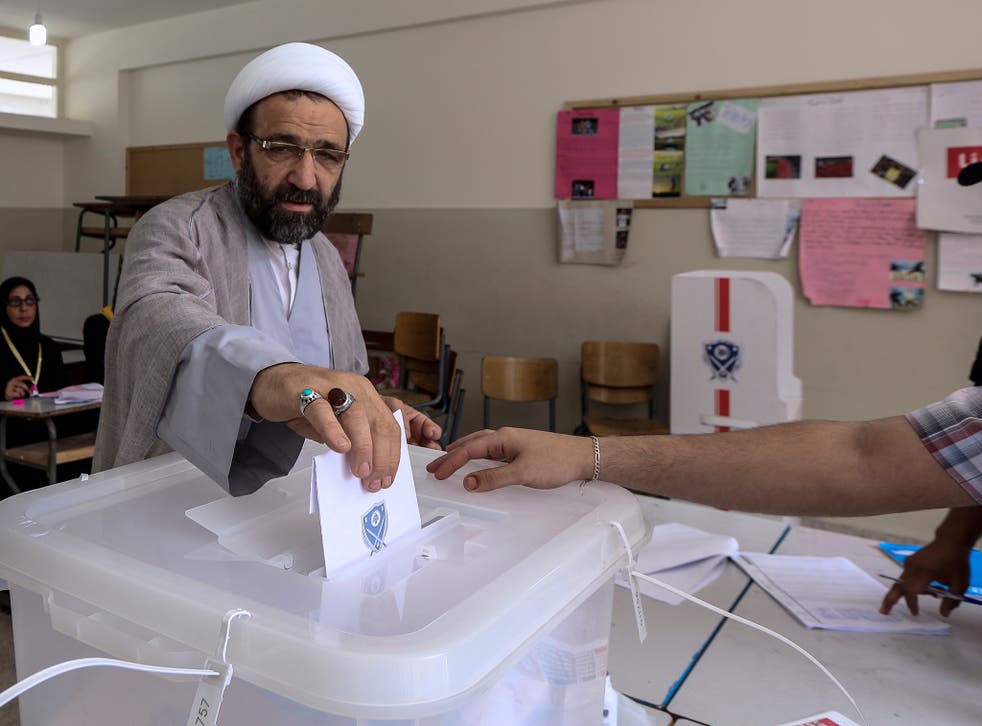 A Lebanese Shiite Cleric casts his vote at a ballot station in Baabda, south east Beirut