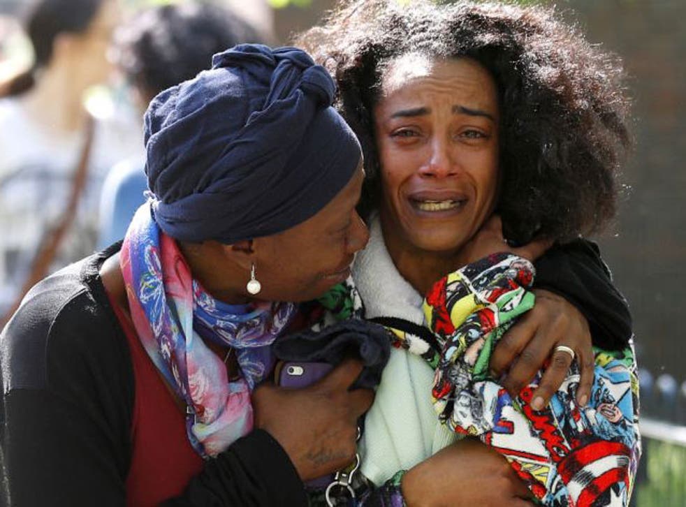 Pretana Morgan (right) is comforted as she grieves for her son Rhyhiem Ainsworth Barton, who was shot dead aged 17