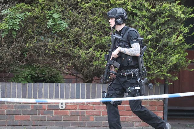 An armed police officer at the scene of the stand-off