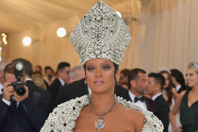 Rihanna poses on the Met Gala red carpet