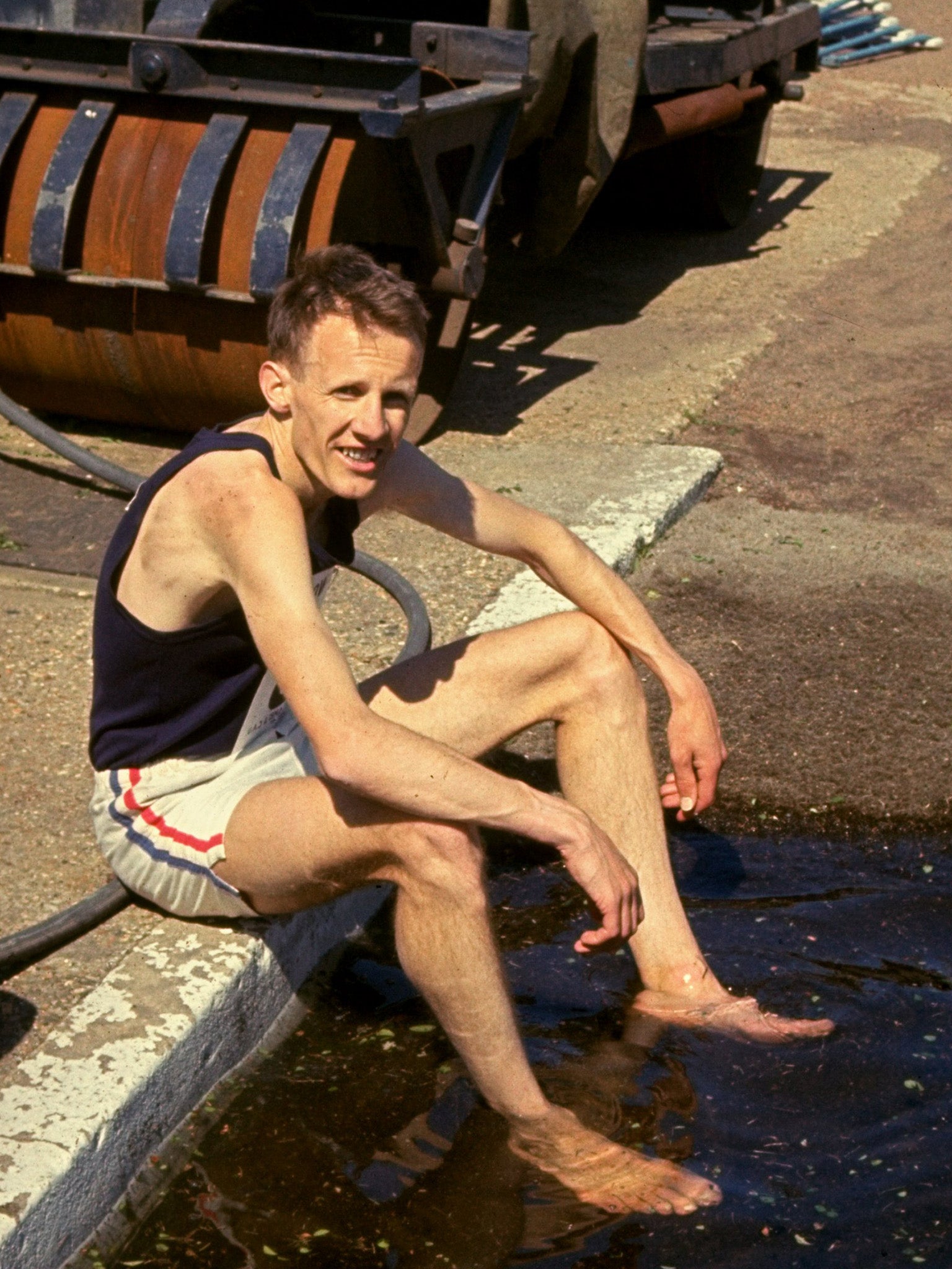 Tulloh cools his feet in the water jump after a race at White City Stadium in London