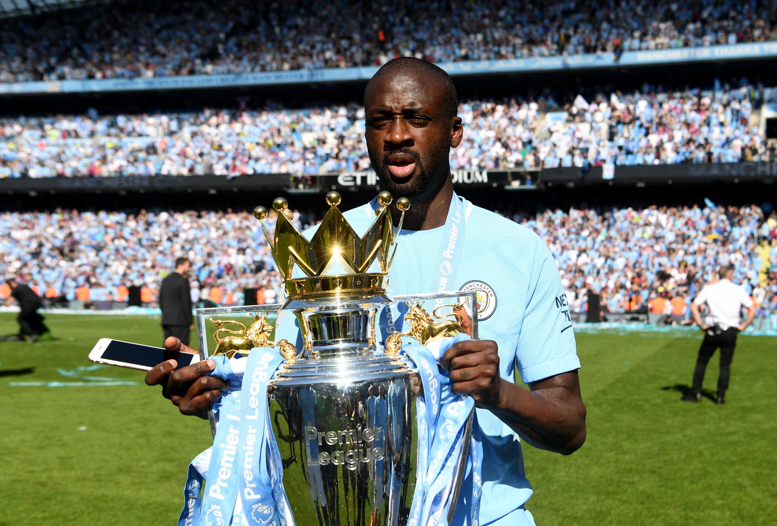 Yaya Toure celebrates with the Premier League trophy