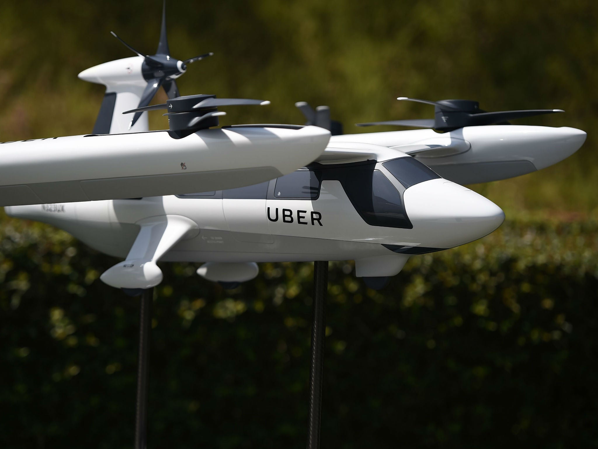 A model of Uber's electric vertical take-off and landing vehicle concept flying taxi is displayed at the second annual Uber Elevate Summit in Los Angeles, California