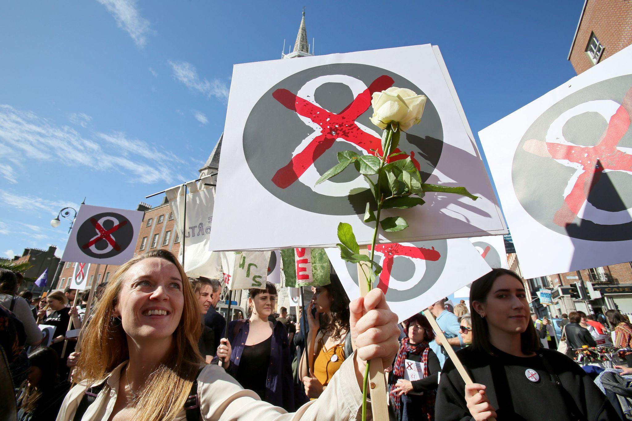 Protesters hold up placards as they take part in the March for Choice, calling for the legalising of abortion in Ireland after the referendum announcement, in Dublin on September 30, 2017