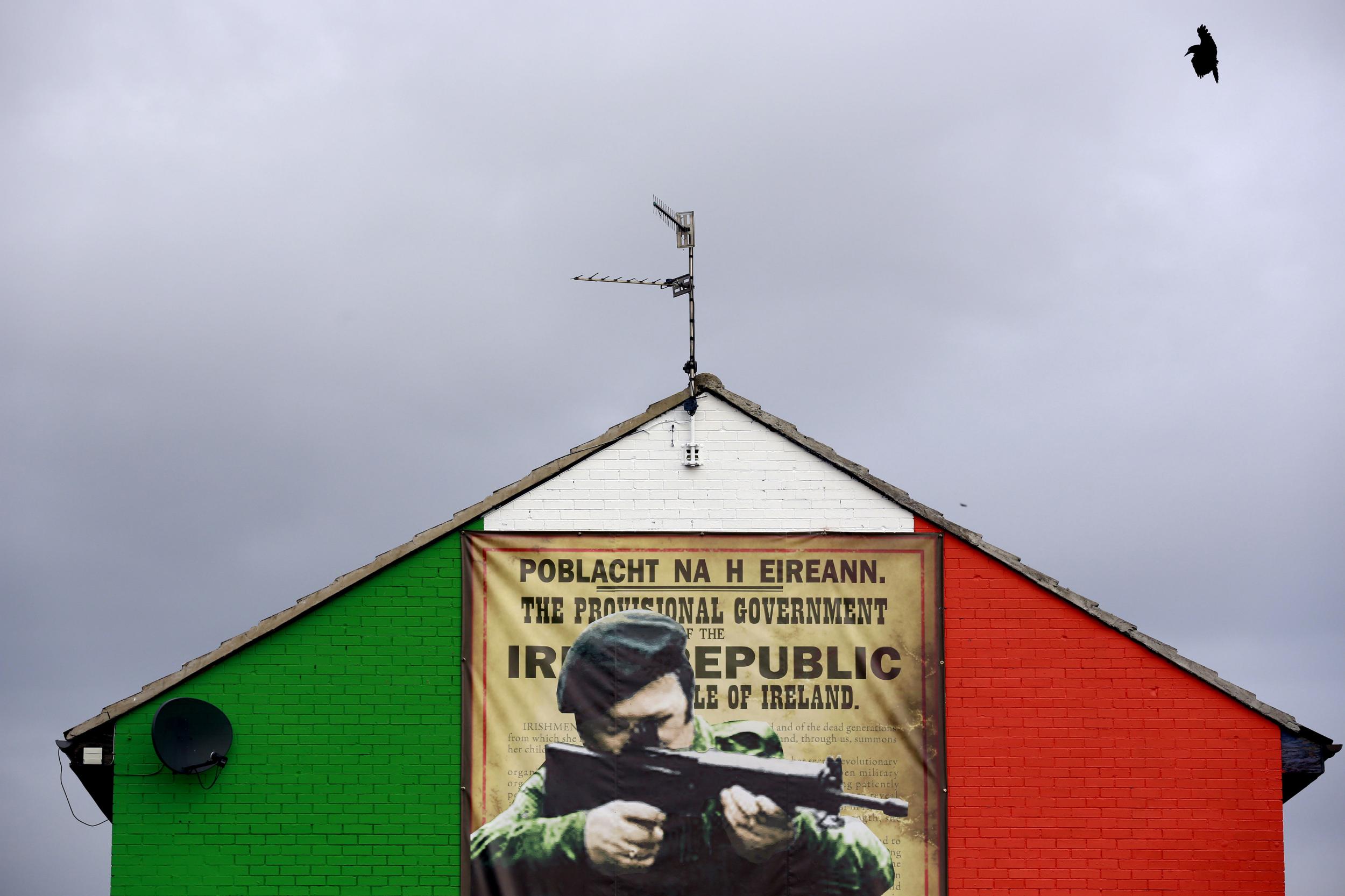 A mural in the Ardoyne area of north Belfast displays an image of an IRA gunman