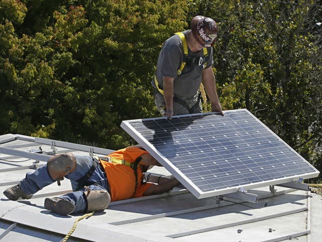 A solar panel is installed on the roof of the California governor's mansion in Sacramento