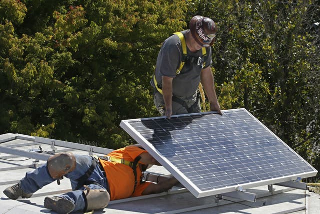 A solar panel is installed on the roof of the California governor's mansion in Sacramento