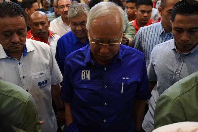 Outgoing Malaysian prime minister Najib Razak looks down as he leaves after addressing the media to concede defeat on 10 May