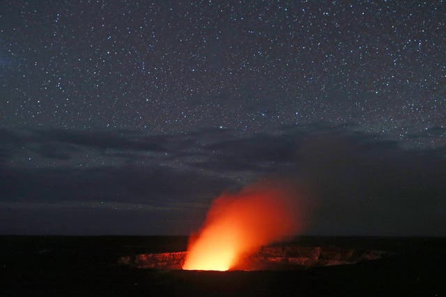 A plume rises from the Halemaumau crater, illuminated by glow from the crater's lava lake, within the Kilauea volcano summit at the Hawaii Volcanoes National Park on May 9, 2018 in Hawaii Volcanoes National Park, Hawaii