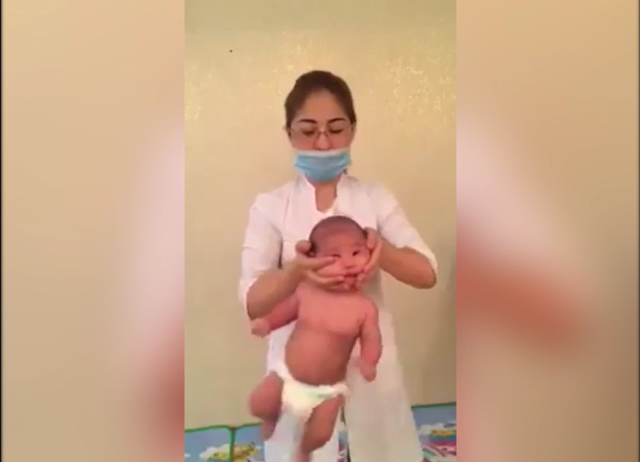 A video depicting Larissa Orynbasarovna carrying out a 'baby massage' has sparked outrage