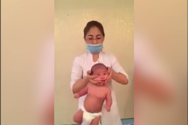 A video depicting Larissa Orynbasarovna carrying out a 'baby massage' has sparked outrage