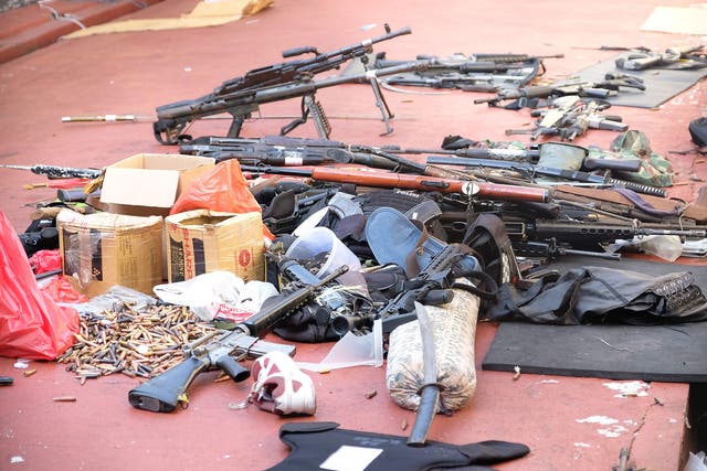 Firearms, ammunition, and bulletproof gear that prisoners used during a riot at the Mobile Police Brigade headquarters in Depok