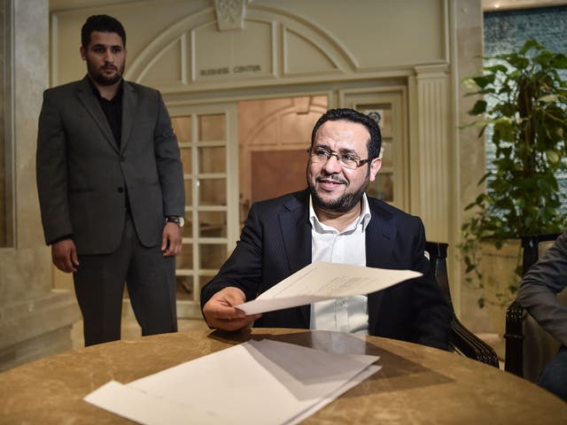 Libyan dissident Abdel Hakim Belhaj reads the letter of apology he received from the UK government, at the British Consulate in Istanbul