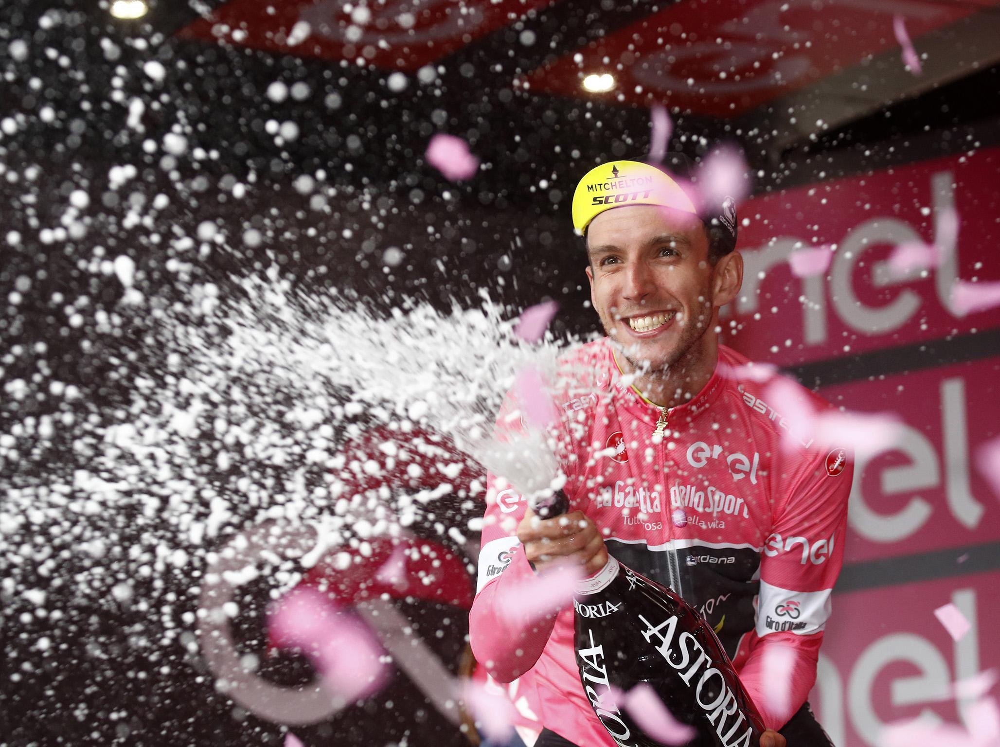 Adam Yates celebrates claiming the pink jersey