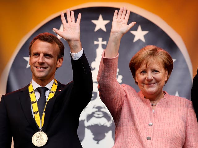 Angela Merkel presented the French president with the prize for his ‘European vision’