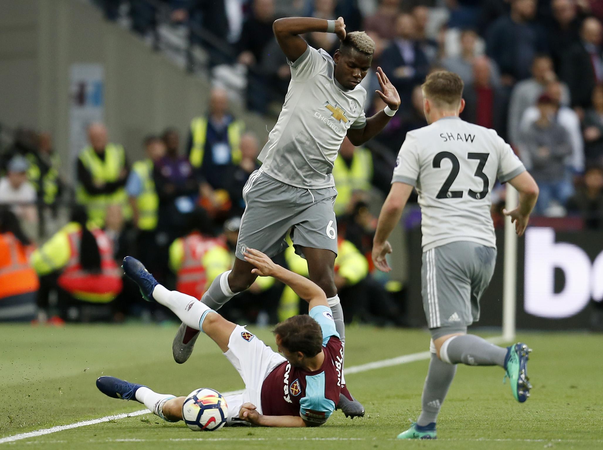 West Ham United’s Mark Noble challenges Paul Pogba