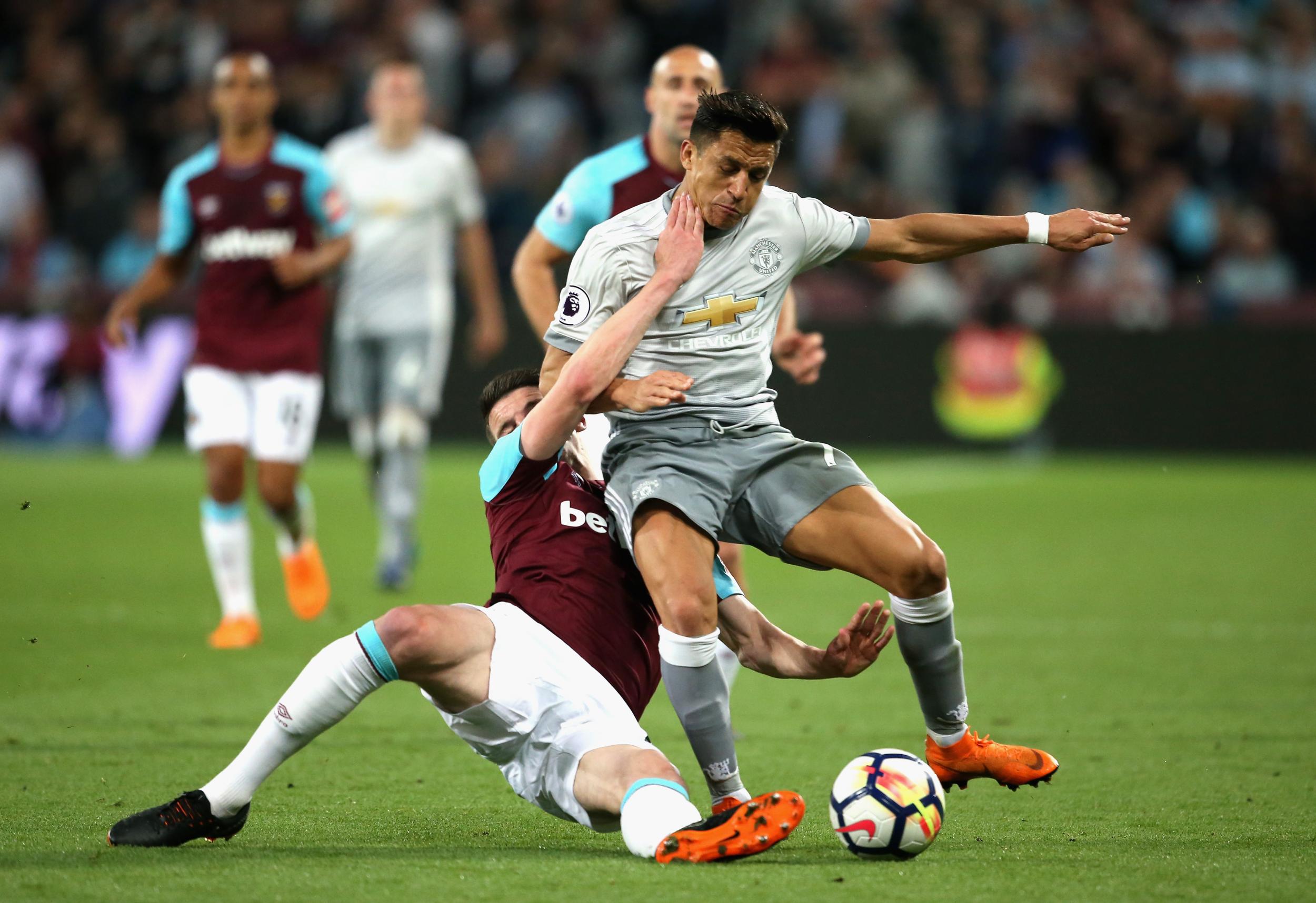 Alexis Sanchez is tackled by Declan Rice