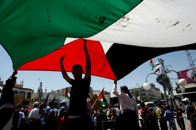 Palestinians flying their flag during the anniversary of Nakba in Rafah, in the southern Gaza Strip, in 2014