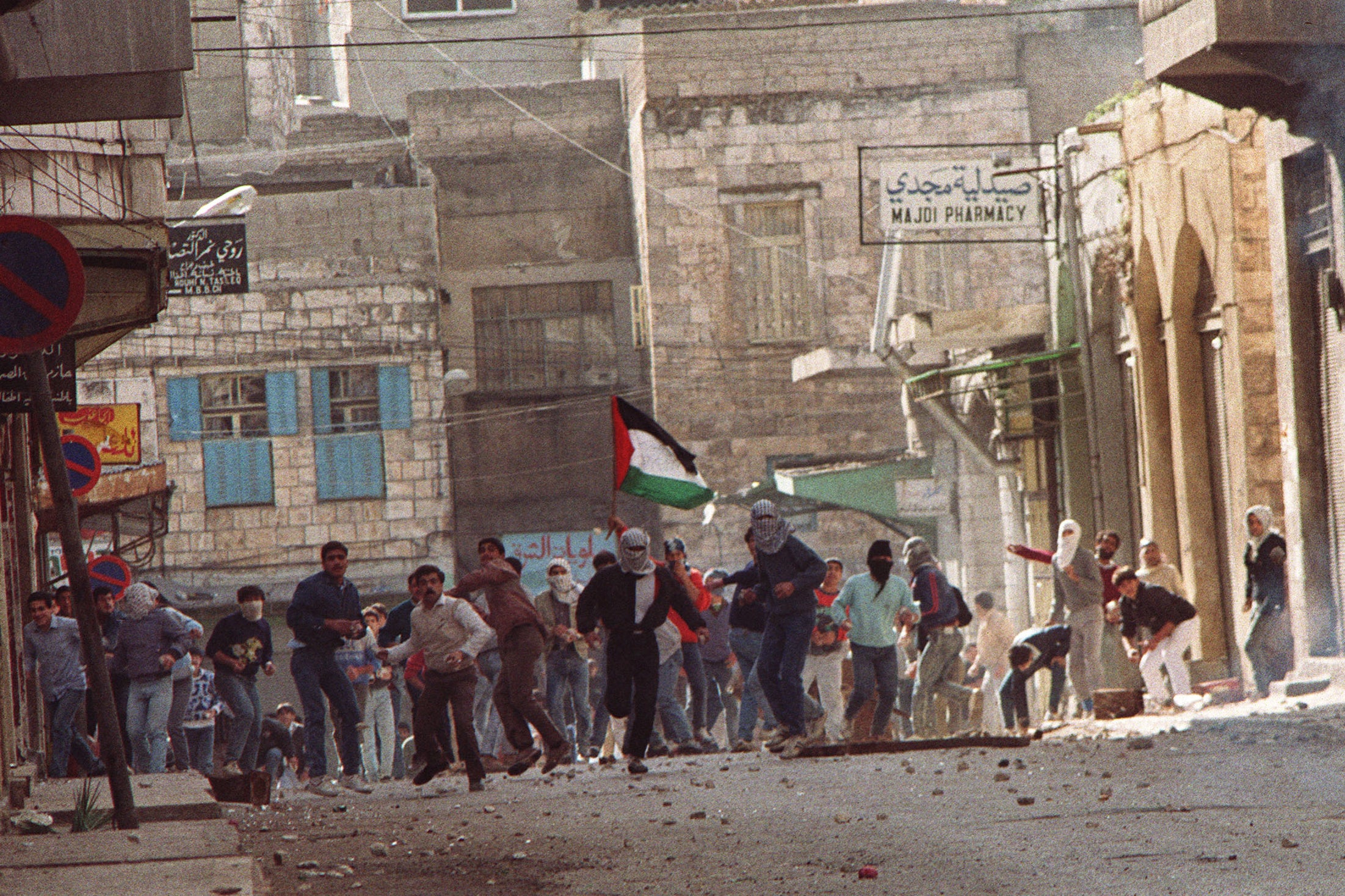 In Nablus, hundreds of protesters raised Palestinians flags and hurled rocks and bottles at Israeli soldiers to protest against the Balata Massacre in 1987