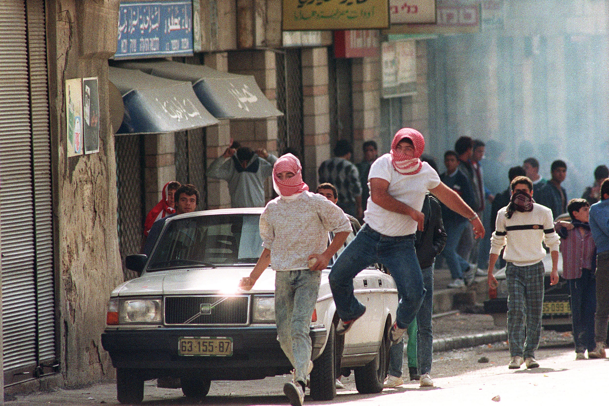 Israeli Arabs throw stones at Israeli riot police in Nazareth, December 1987