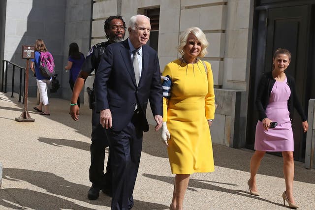 Senator John McCain and his wife Cindy McCain walk out of the Russell Senate Office building toward their car at the US Capitol