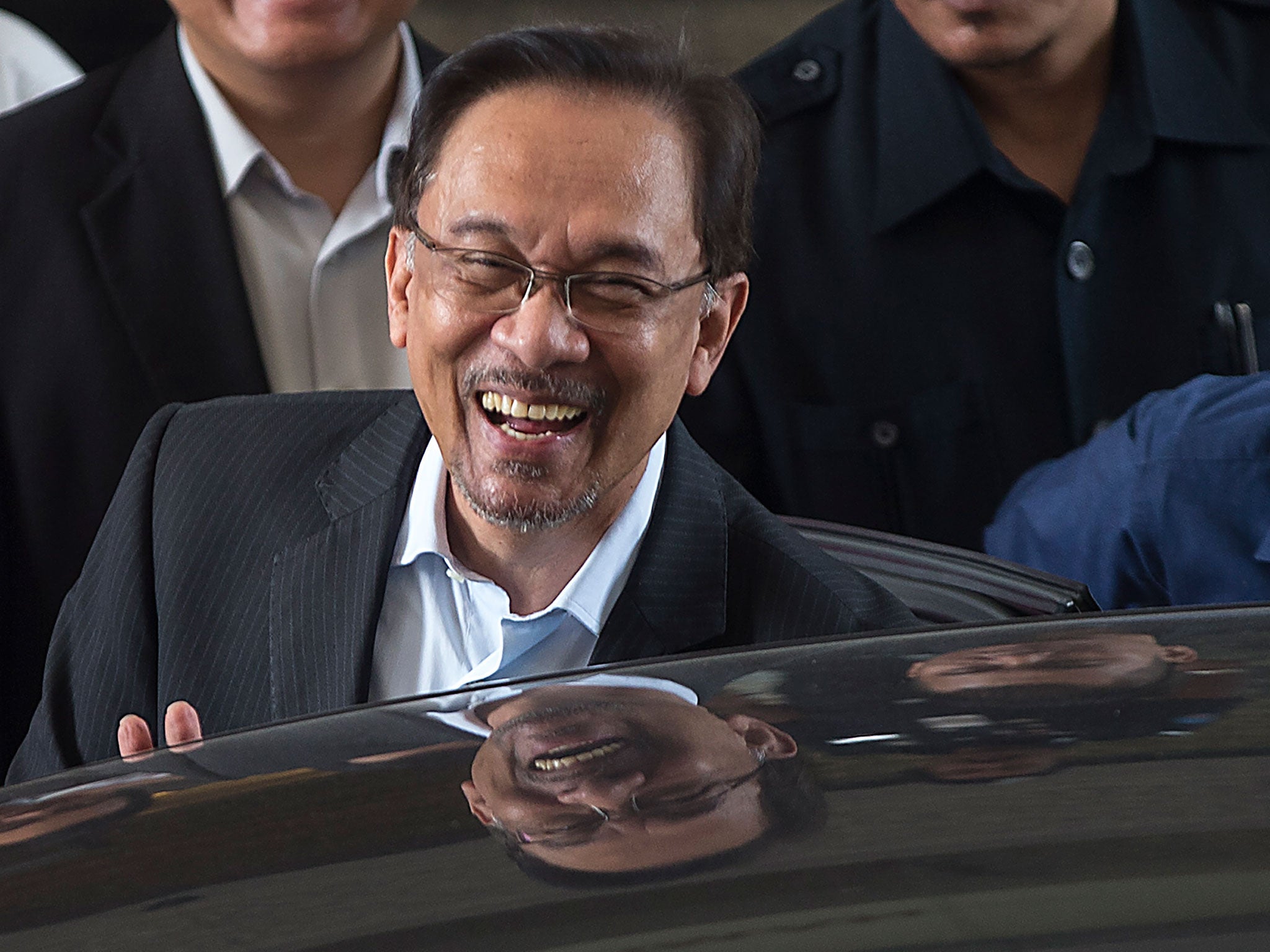 Malaysian opposition leader Anwar Ibrahim smiles as he leave the Palace of Justice in Putrajaya, Malaysia, 3 November 2014